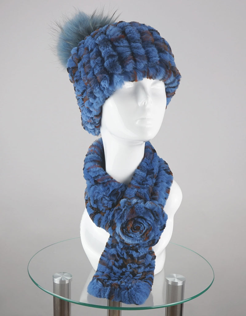 Blue knitted hat and scarf set on a mannequin head against a gray background